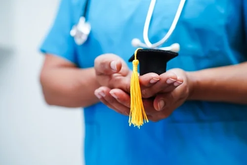 Nursing student holding a graduation cap