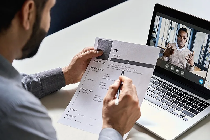Remote job interview and résumé preparation on a laptop