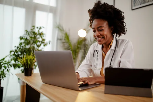 Nurse using a laptop for a career conversation